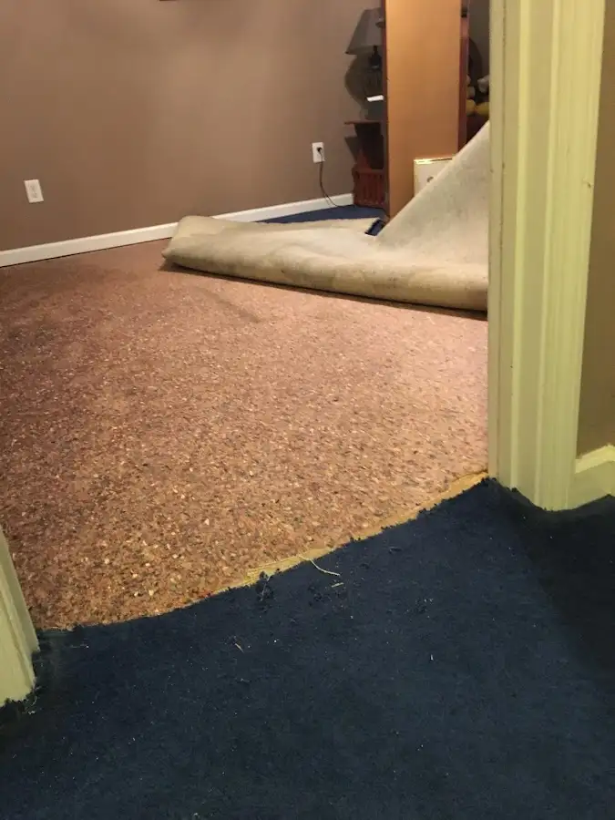 Carpet pad removal revealing water damage during Drying & Dehumidification in Kearns